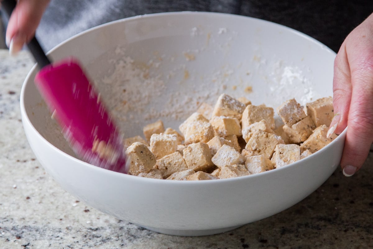 tossing the tofu with cornstarch and baking powder