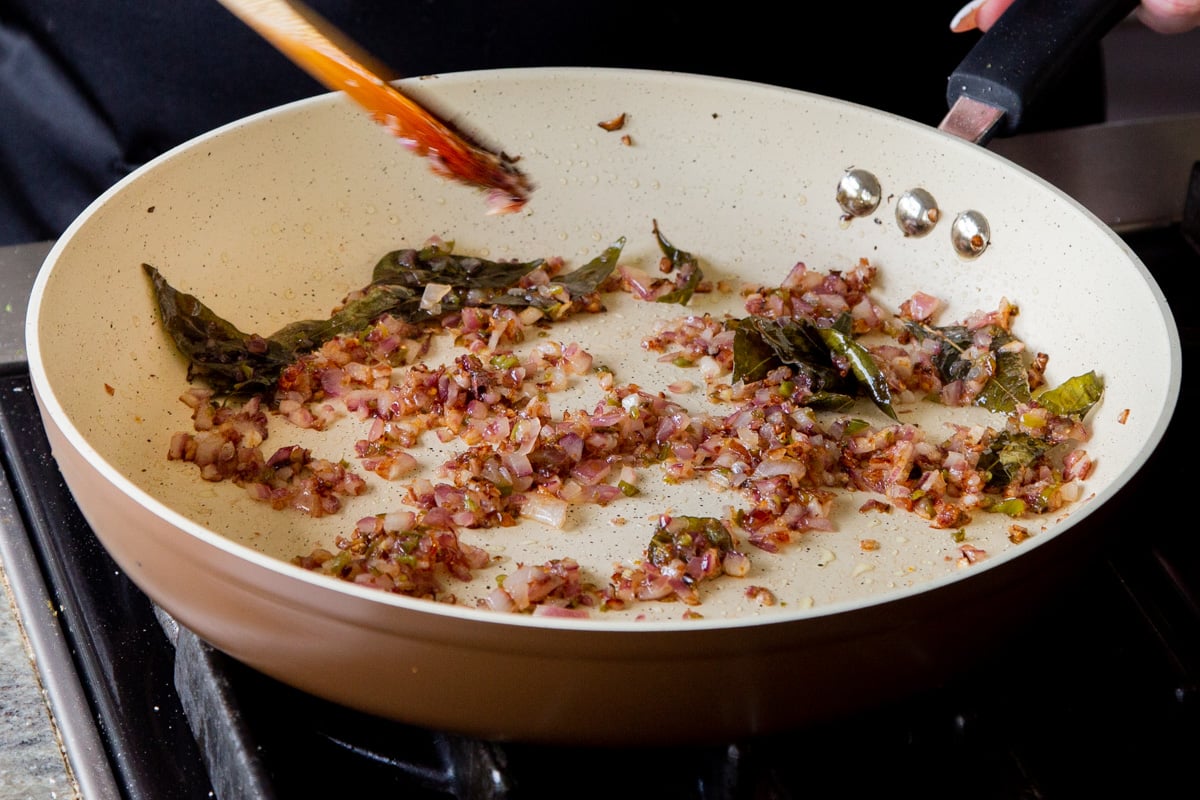 onion, shallot, chili, and curry leaves in the pan after cooking
