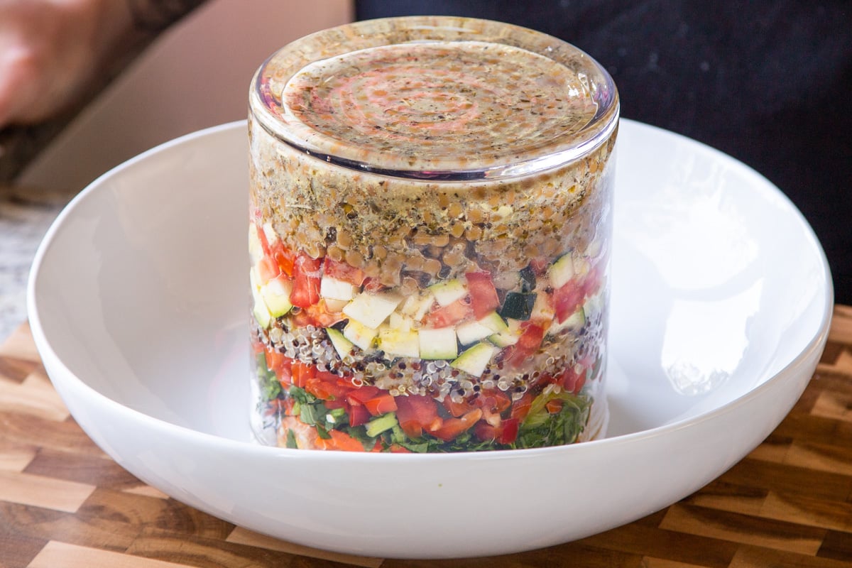 inverting the jar salad into a mixing bowl
