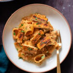 romesco pasta in a bowl with cajun tofu on top