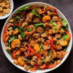 vegan summer salad in a bowl with tofu, croutons, veggies and oranges