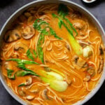 vegan tonkotsu in the pan next to the plate of seared tofu