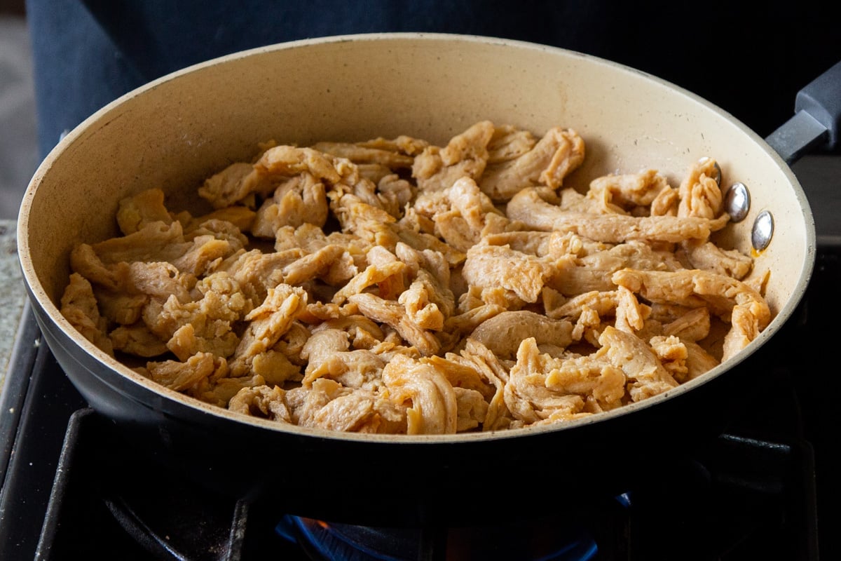 soaked and drained soy curls in a frying pan