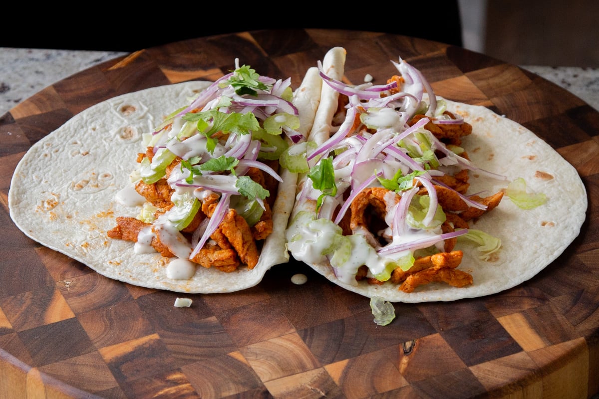 adding onion and vegan ranch to the buffalo cajun wraps