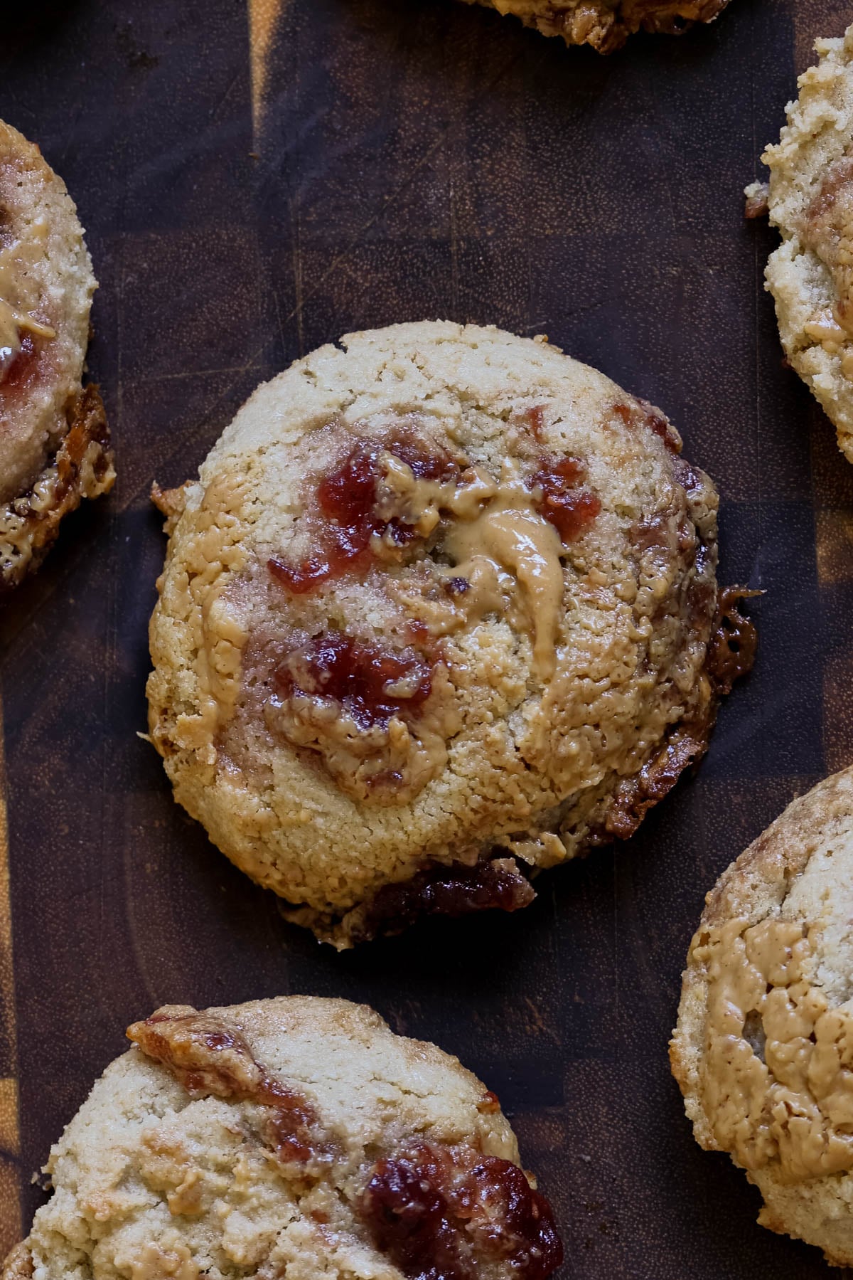 close-up of gluten-free peanut butter and jelly cookies on a wooden cutting board