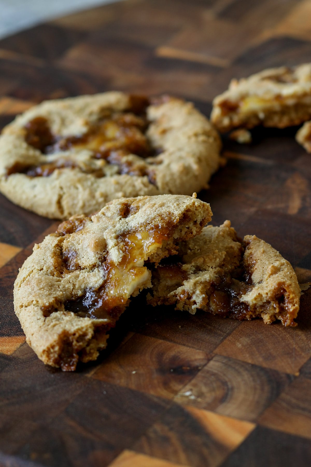 tiramisu cookie broken in half on a cutting board