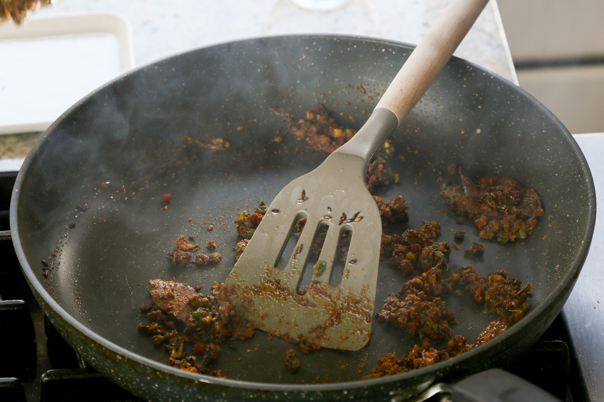 mixing the ground spices and aromatics