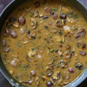 vegan mushroom gravy in the pan, after adding back the mushrooms and simmering