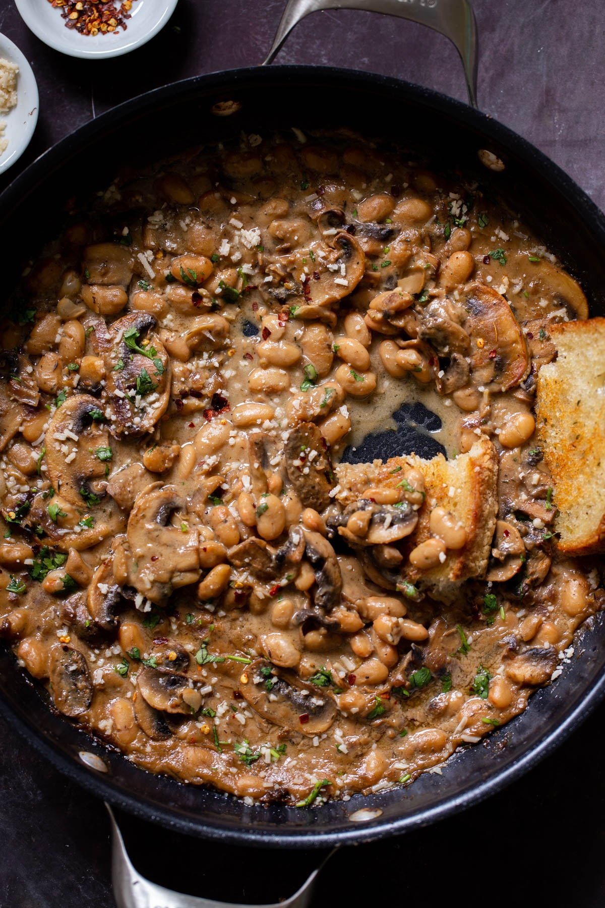 white bean stroganoff in the pan after dipping with toast