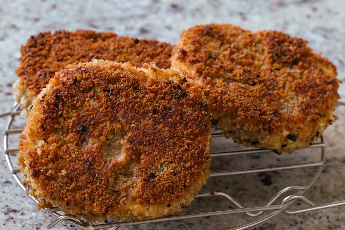 crispy vegan chicken cutlets on a wire rack