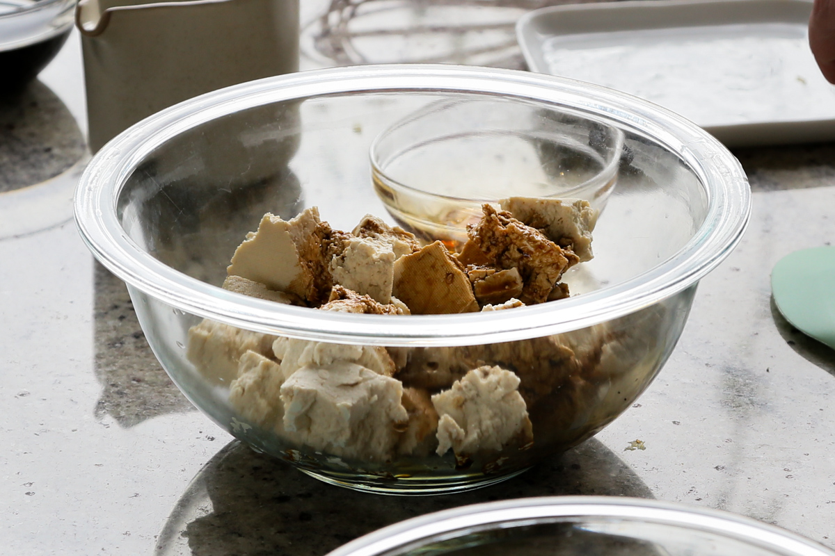 adding seasoning to the tofu