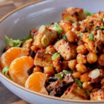 gochujang tofu and veggies in bowl over lettuce