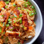 close-up of peanut gochujang rice topped with tofu and green onions in a bowl