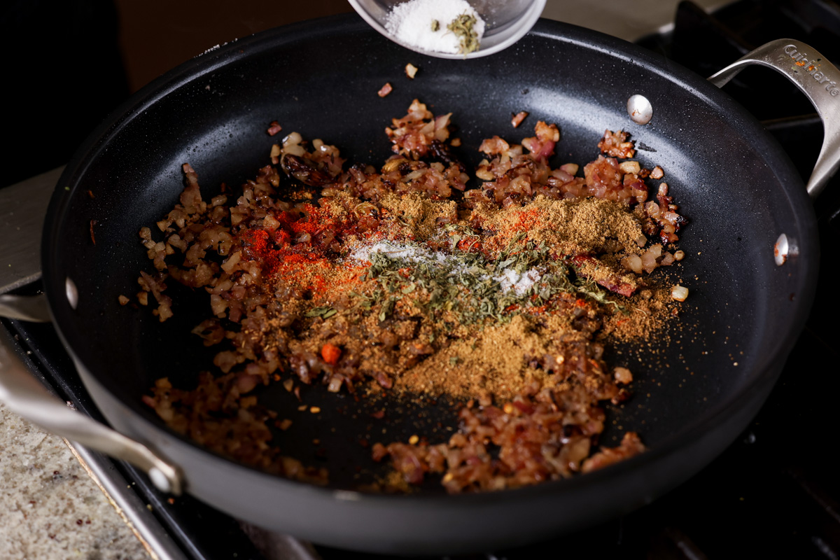 adding ground spices to the pan