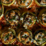 close-up of zucchini rolls in the baking dish after baking