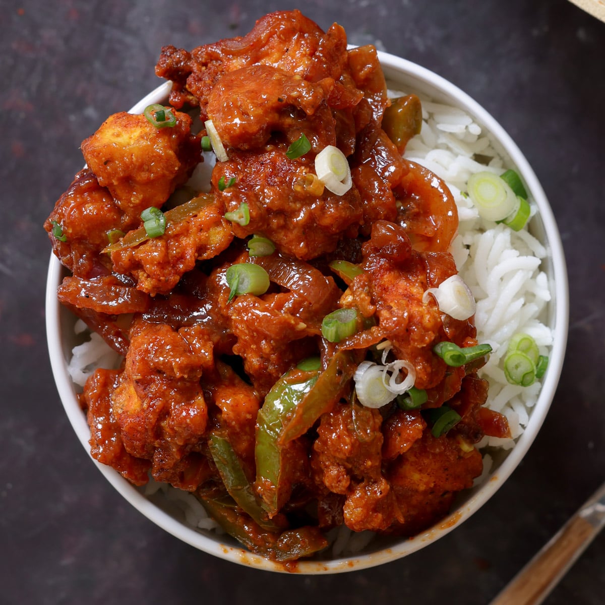tofu kondattam in a bowl over rice