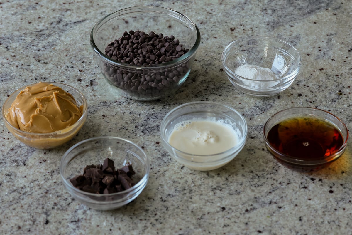 chocolate chips, almond butter, and other brownie ingredients on the kitchen counter