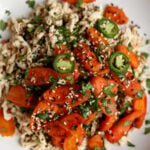 shredded tofu topped with roasted carrots in a bowl