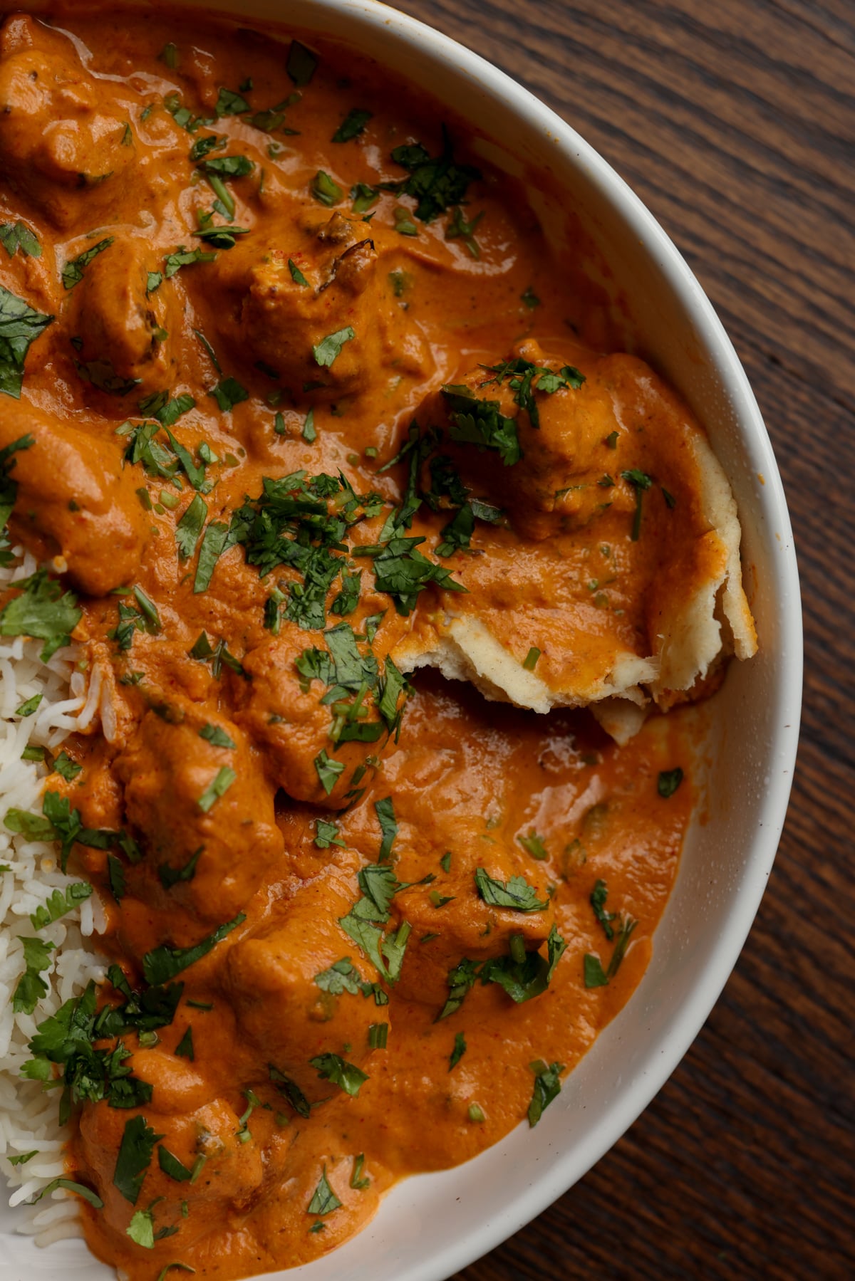 plate of vegan butter chicken with naan