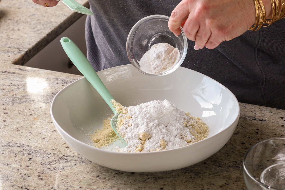 adding dry ingredients to the bowl