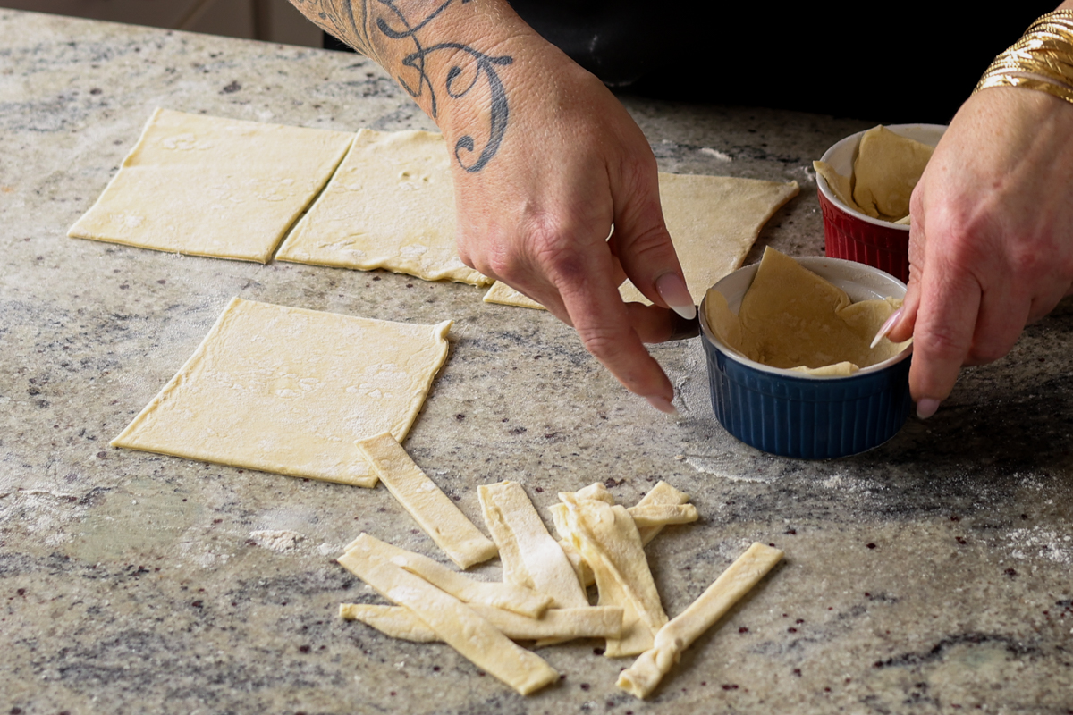 timing puff pastry into squares and adding to ramekins