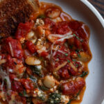 close-up of butterbean parmigiana on a plate with toasted sourdough