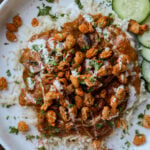 balchao mushrooms over rice topped with crispy beans
