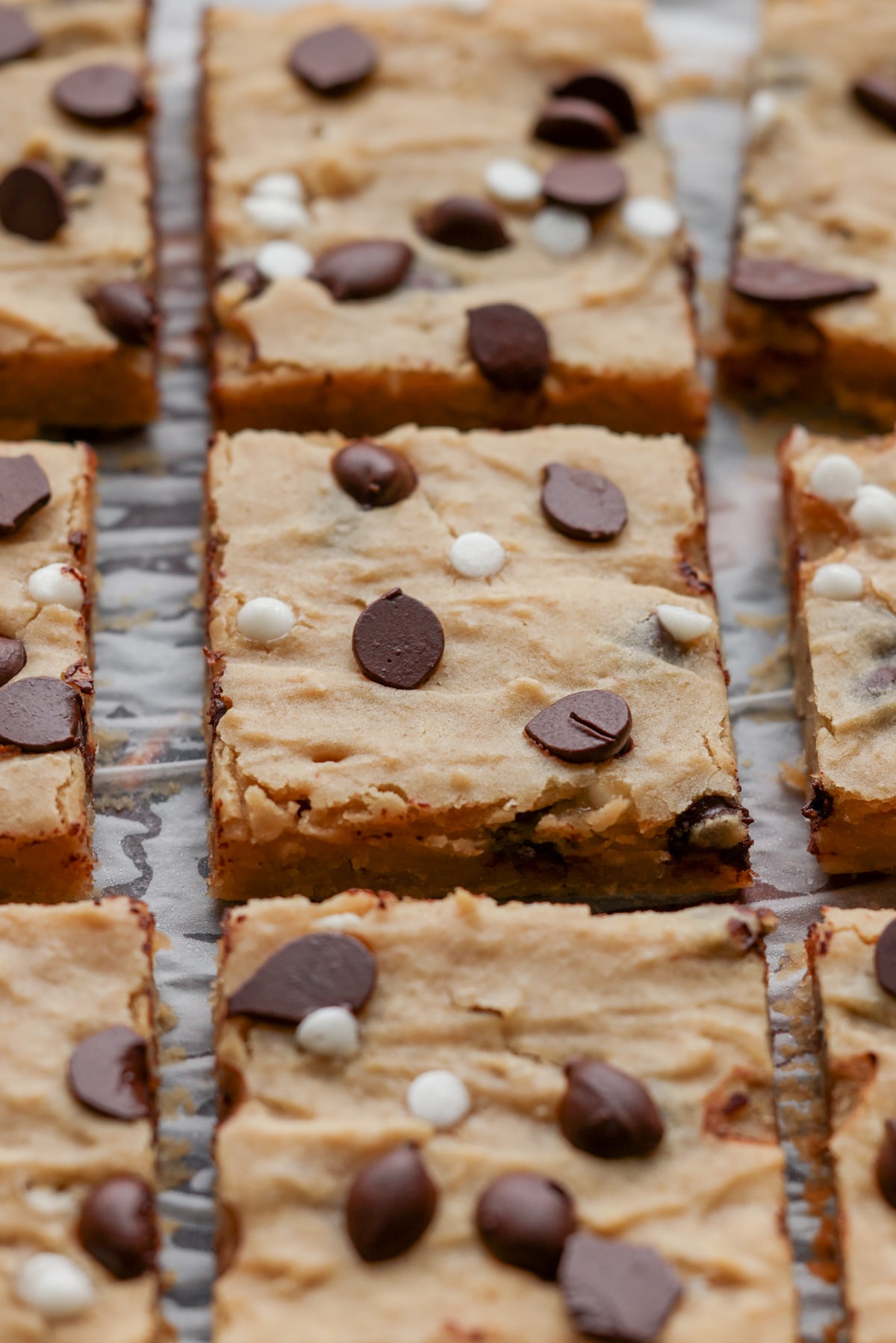 close-up of sliced white bean blondies on parchment paper