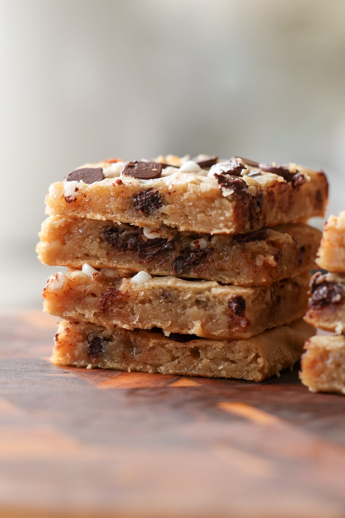close-up of sliced white bean blondies on a cutting board, so you can see the texture inside