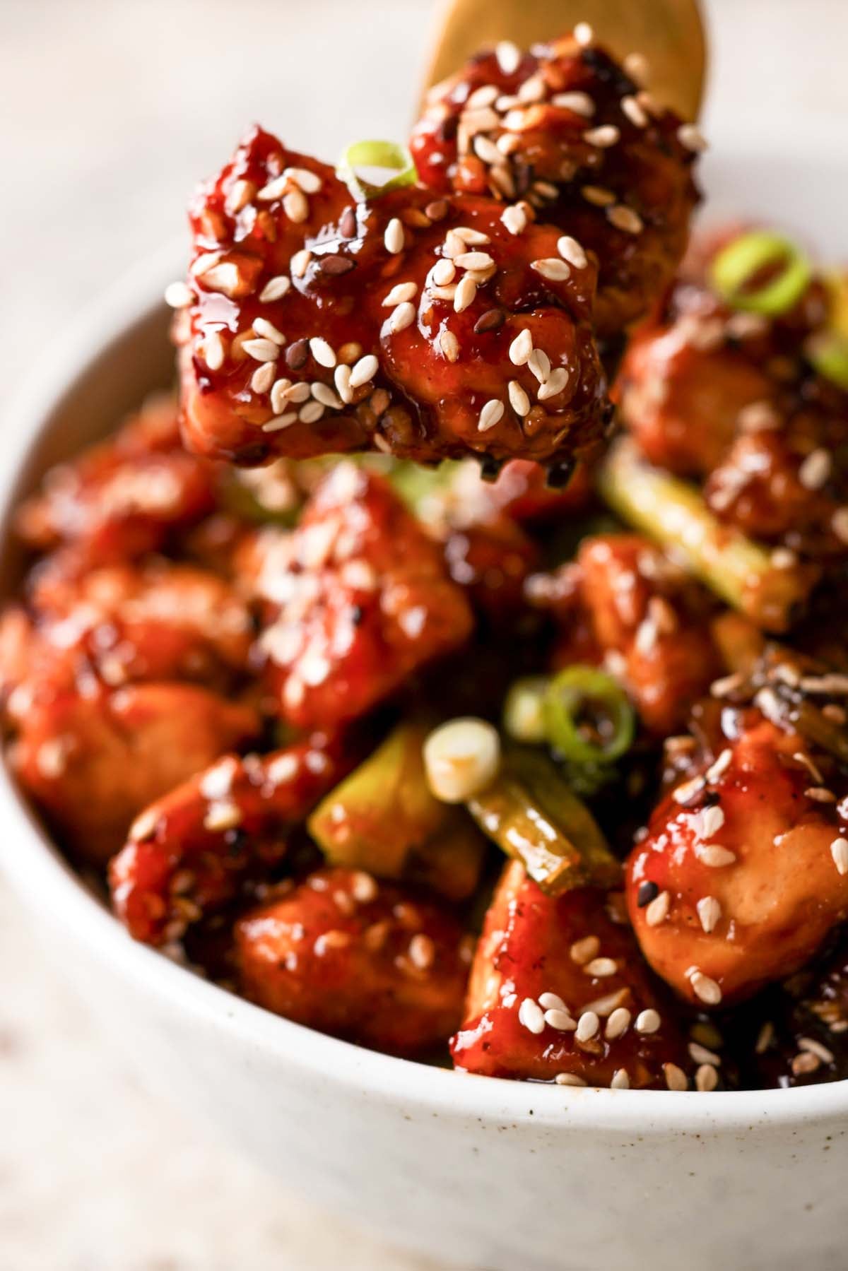 fork taking a bite of teriyaki tofu