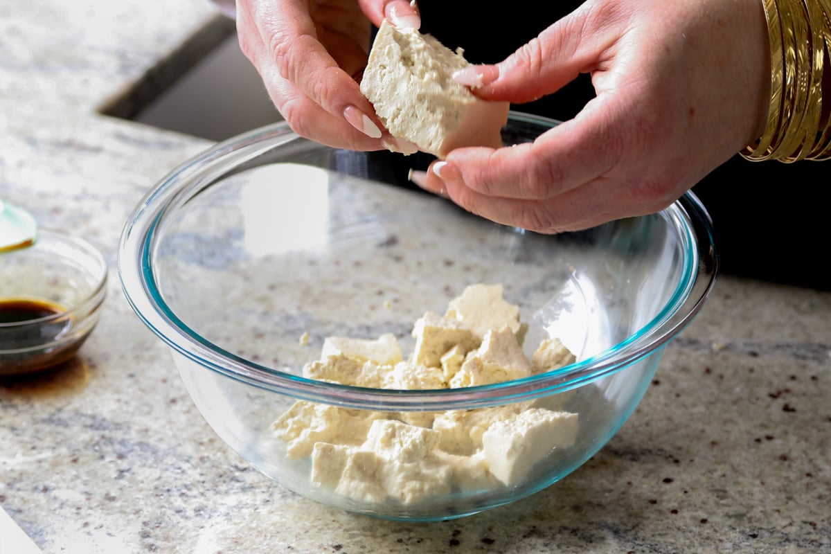 tearing the tofu into pieces
