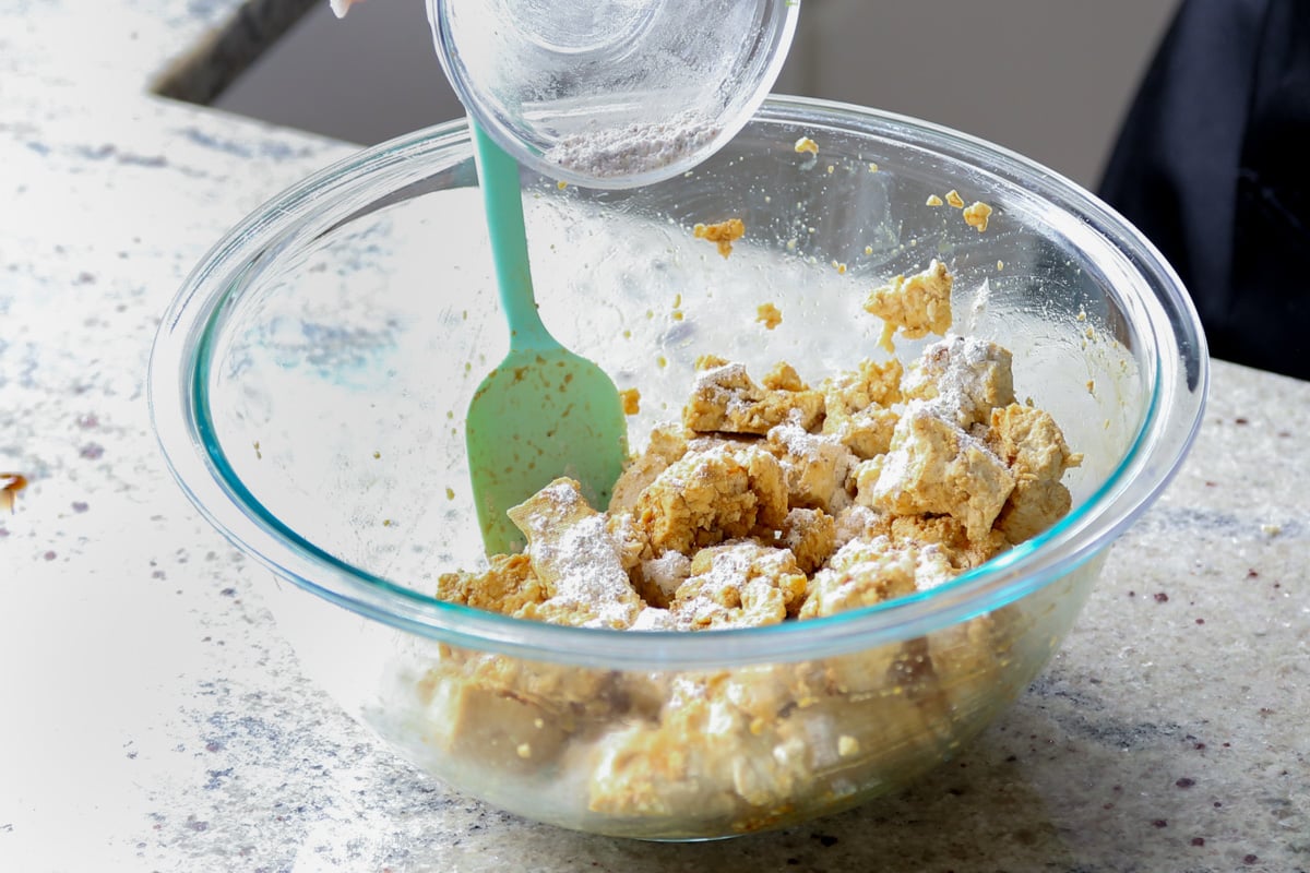 adding cornstarch and spices to the tofu