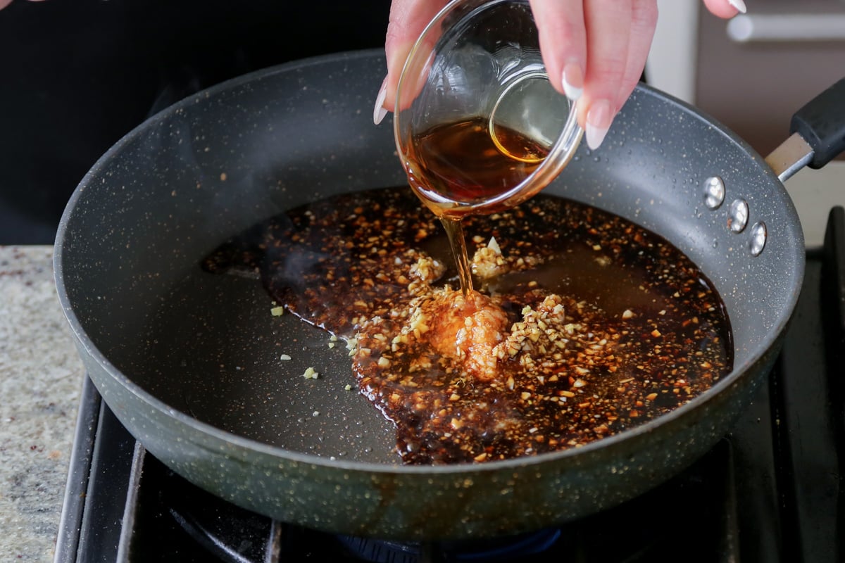 adding aromatics and sauces to the empty pan