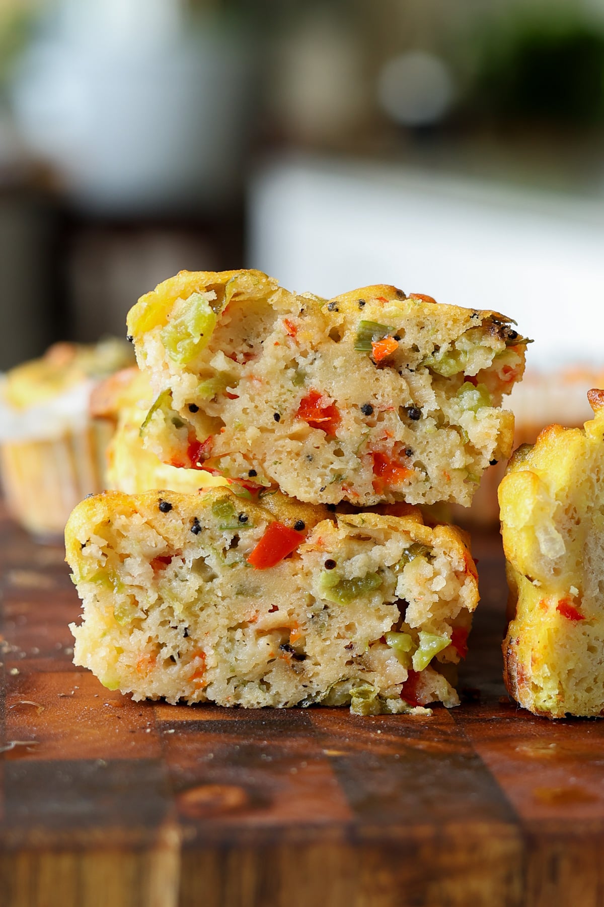 close-up of moong egg muffins on the cutting board with one cut in half, so you can see the inside