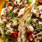 close-up of chipotle whipped tofu, roasted zucchini, and crispy lentils tacos
