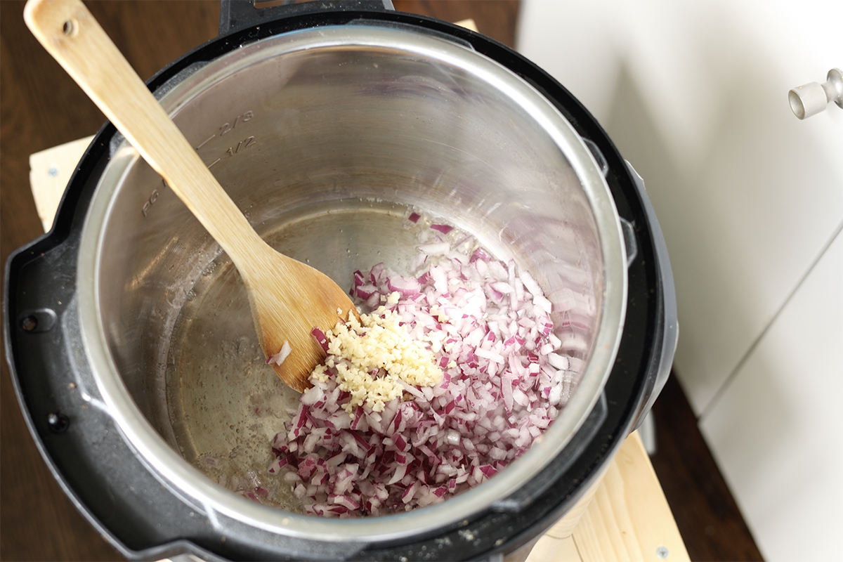 adding onion and garlic to the Instant Pot