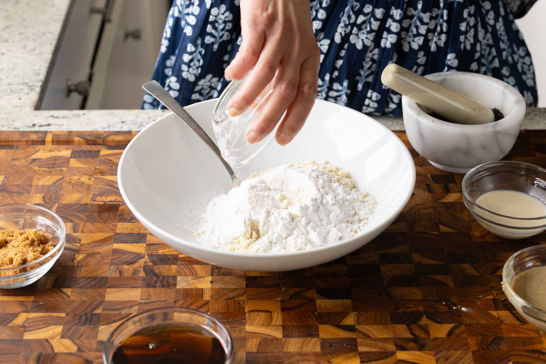 adding dry ingredients to the bowl