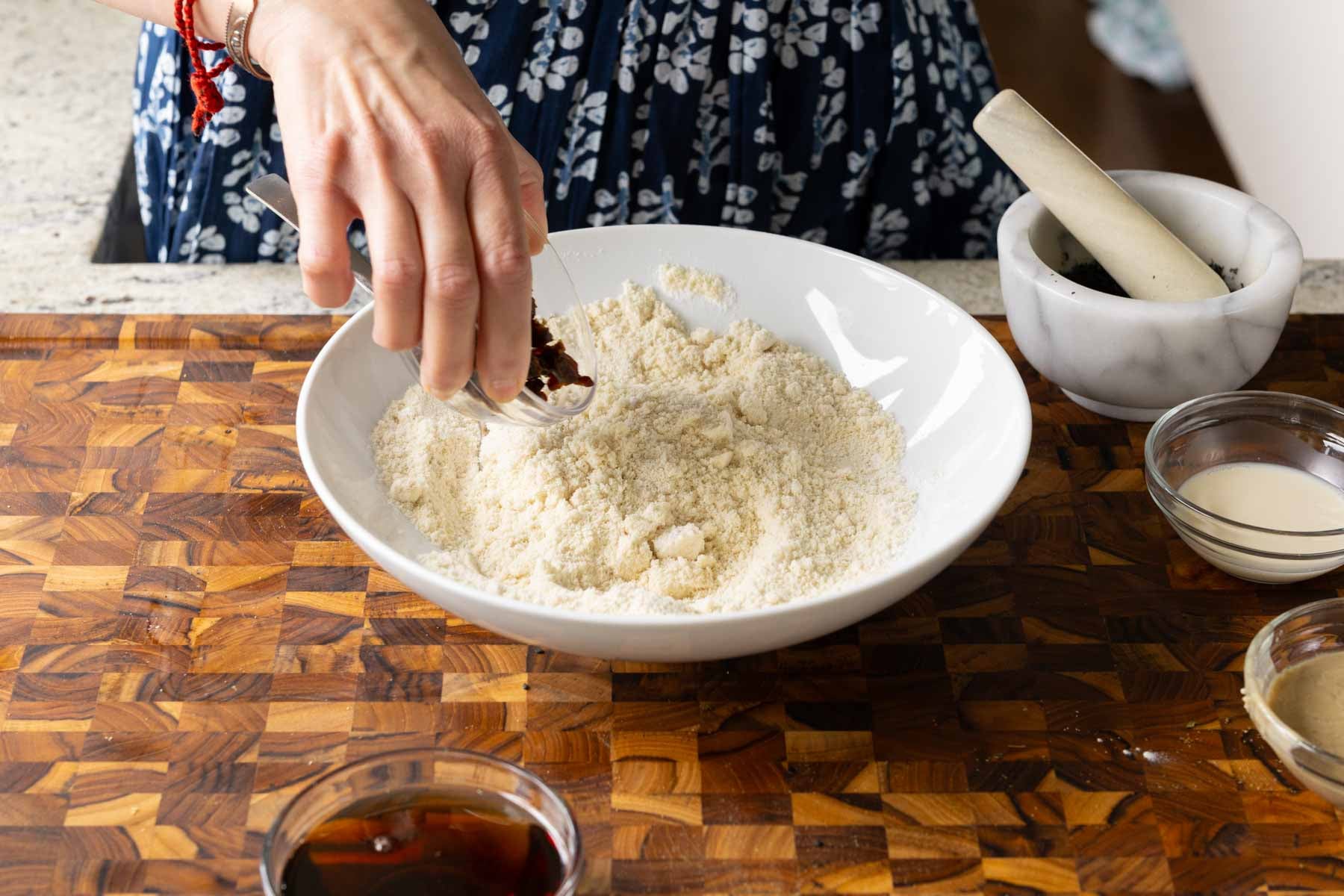 adding dates and black sesame seed to the mixed dry ingredients