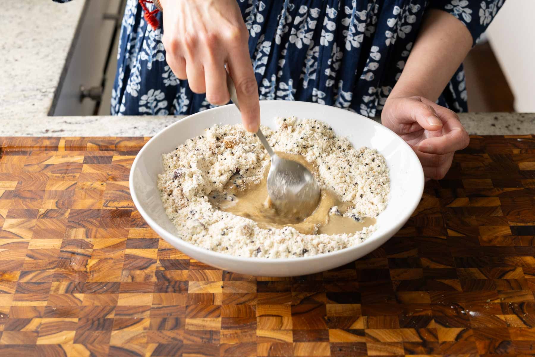 mixing the wet ingredients in the well of dry ingredients