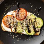 whipped tofu toast on a black plate
