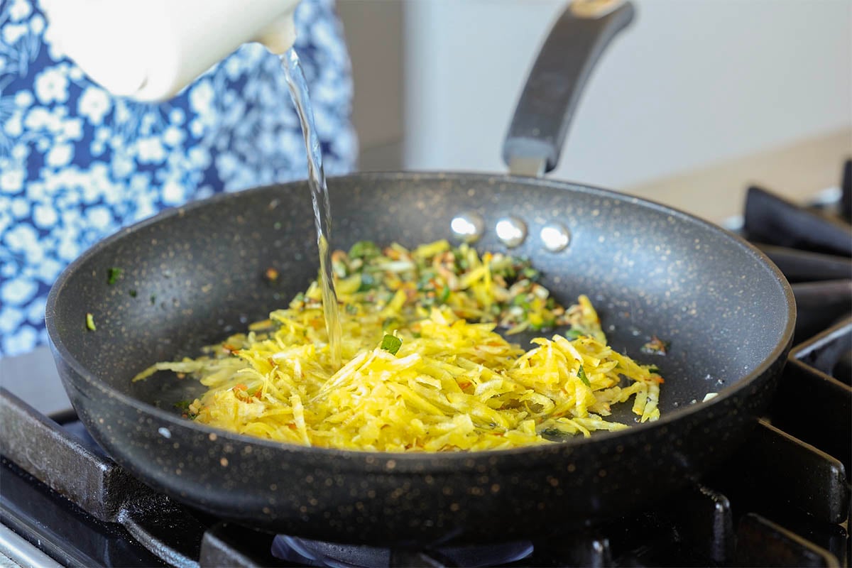 adding water to the pan