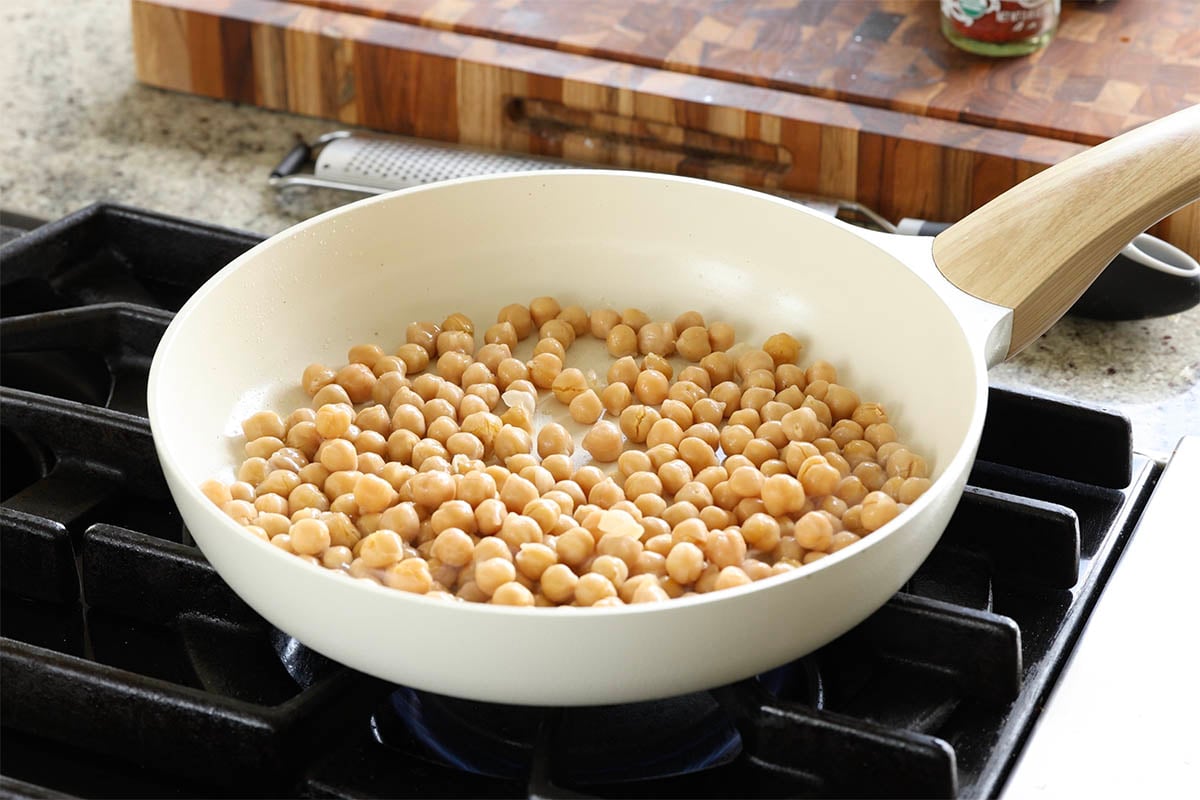 adding chickpeas to the pan