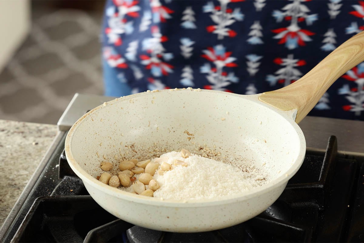 coconut and peanuts in the pan before toasting
