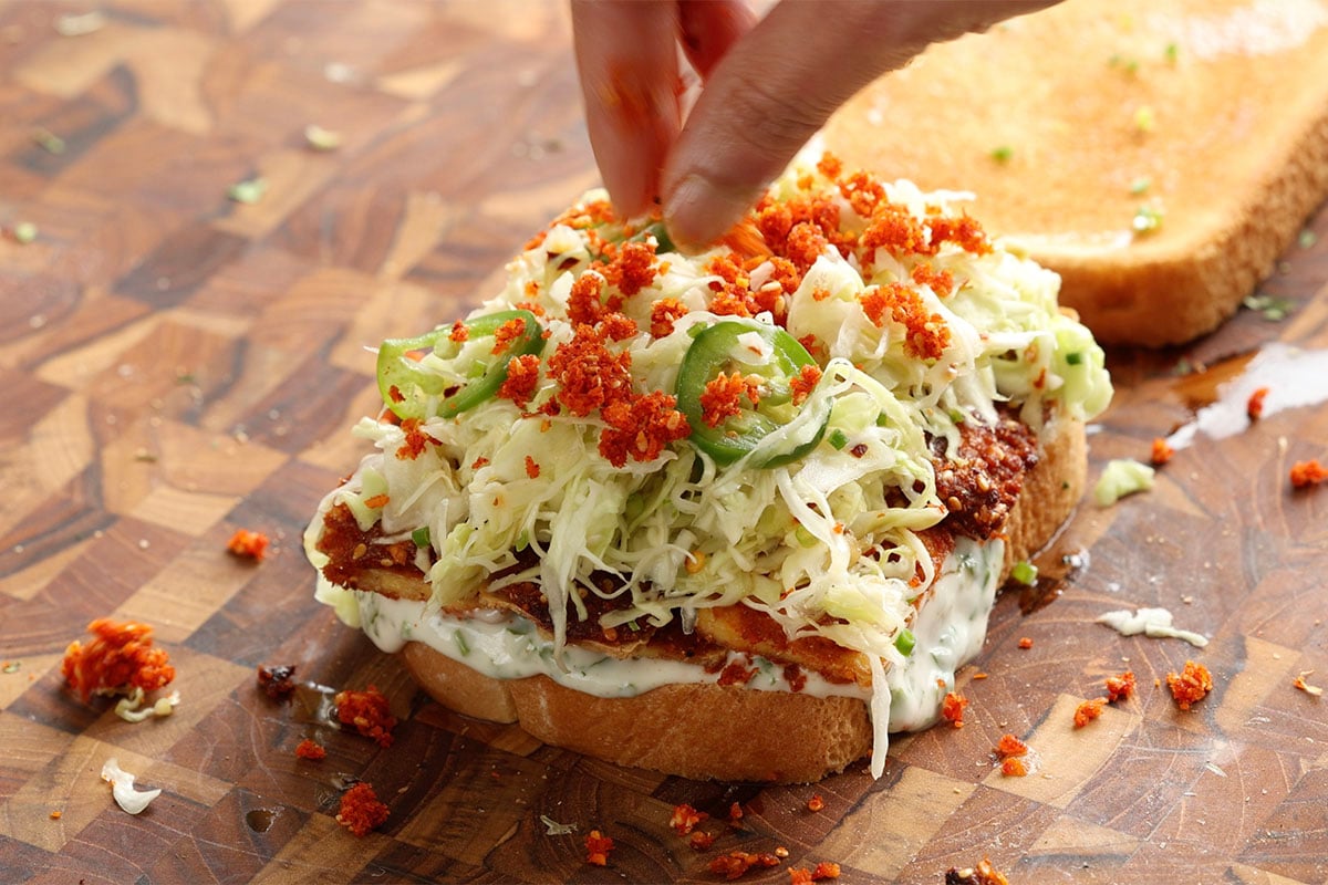 adding extra chutney to the sandwich