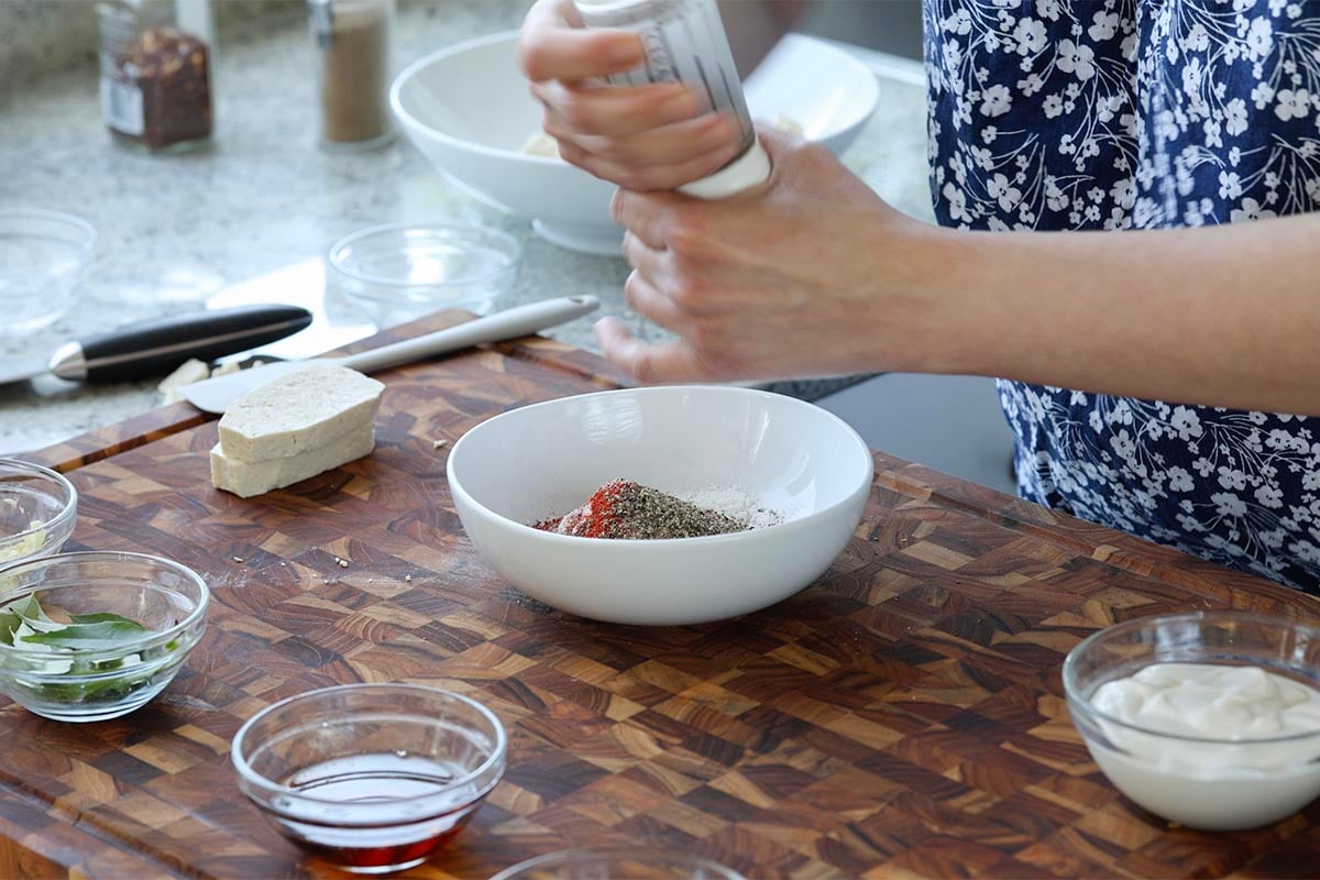 adding the spice mixture to a bowl