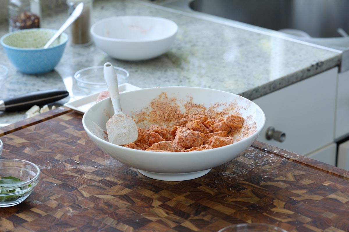 tofu pieces in the bowl, coated in the spice mixture