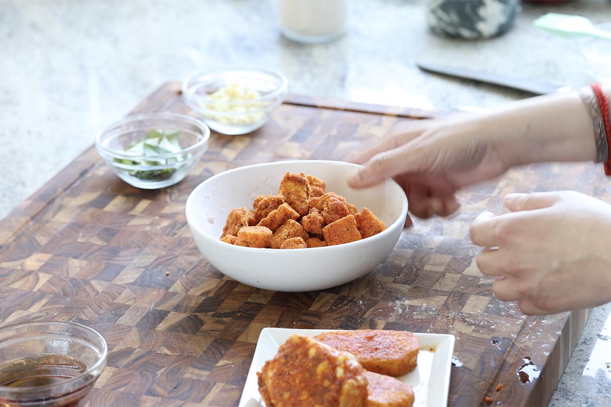 tofu pieces in a bowl after air frying