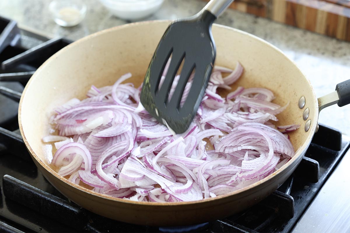 adding onions to the pan
