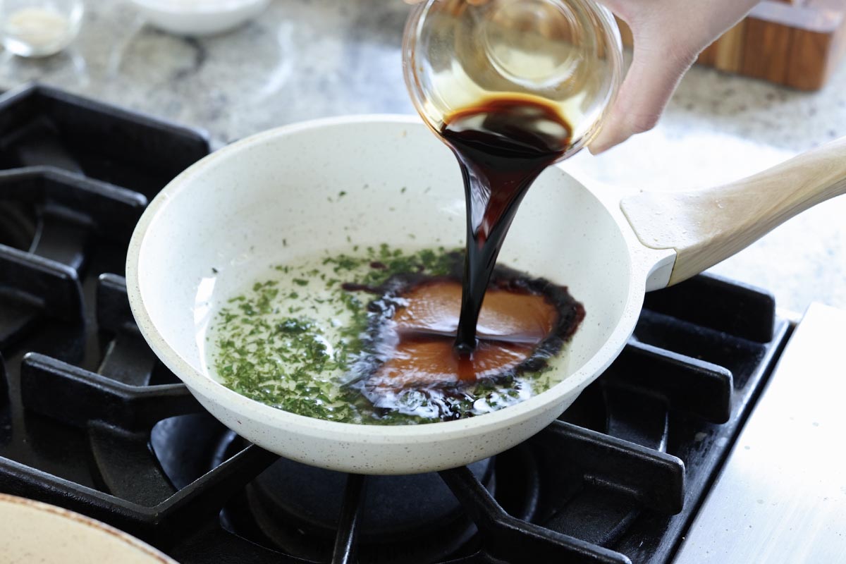 adding glaze ingredients to the curry leaf oil