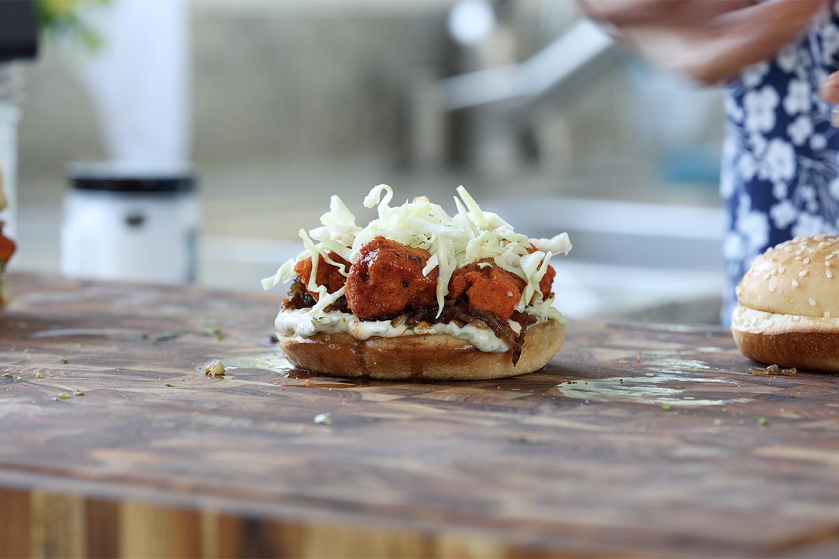 adding slaw to the sandwich